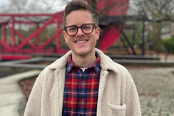 JK Doran, Lib Dem candidate for Rotherhithe, stands in front of the Red Bridge nearby Surrey Water and Thames Link