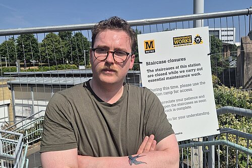 Ciaran Morrissey standing in front of blocked off steps at University Metro station