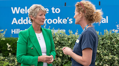 Pippa Heylings talking to a member of NHS medical staff outside Addenbrookes Hospital