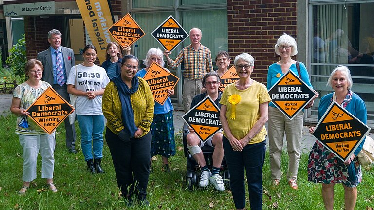 A picture of Lewisham LibDem members with Hina Bhokari AM. The picture includes a wheelchair user and a woman of colour wearing a 50:50 parliament t-shirt.