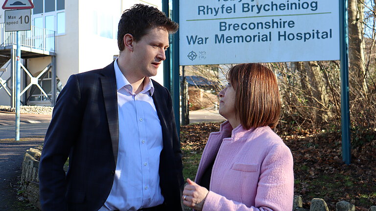 Jane and David speaking outside a hospital