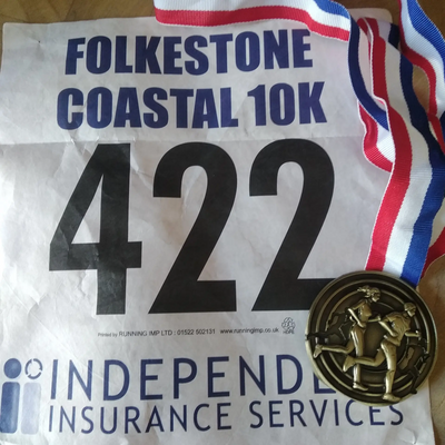 Folkestone Coastal 10km run - runners number and medal