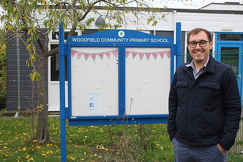Tom Gordon MP stood in front of Woodfield Primary School 