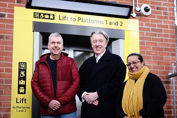 Councillors Hina Bokhari, John Oliver and Paul Kohler MP stood in front of new Motspur Park lift
