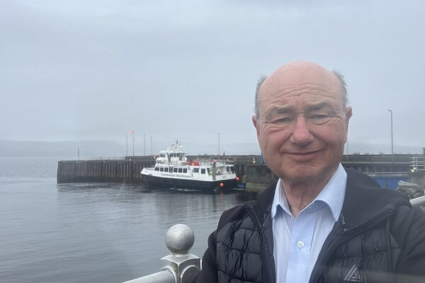 Alan at Dunoon Harbour with catamaran docked behind him