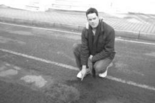 Cllr Gavin James (left) with some of the 250 potholes reported by the Lib Dems in one week