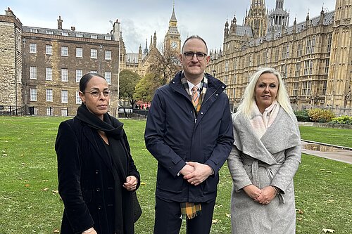Ian Sollom with two members of impacted families