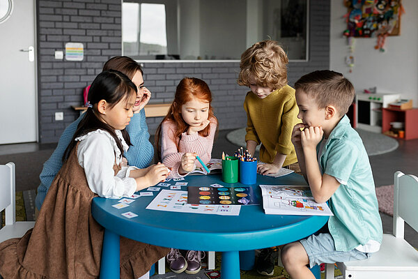 Children sat around a table playing