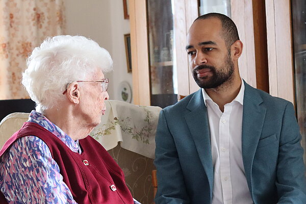 Josh speaking to an elderly resident