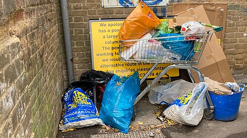 streetlight information sign obscured by rubbish in Billy Fury Way