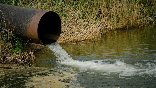 A sewage pipe running into a body of water