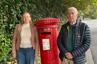Claire and Nigel by a post box