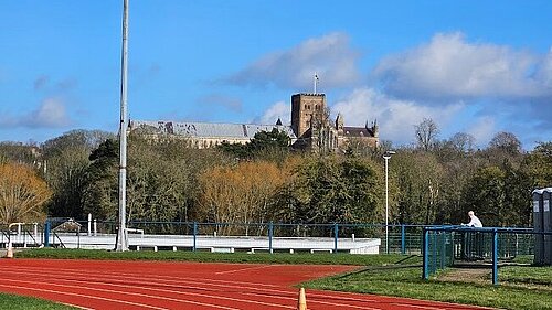 Photograph of Abbey View Athletics Track with the Cathedral in the background 