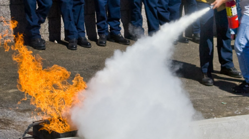 A fire being put out by an extinguisher