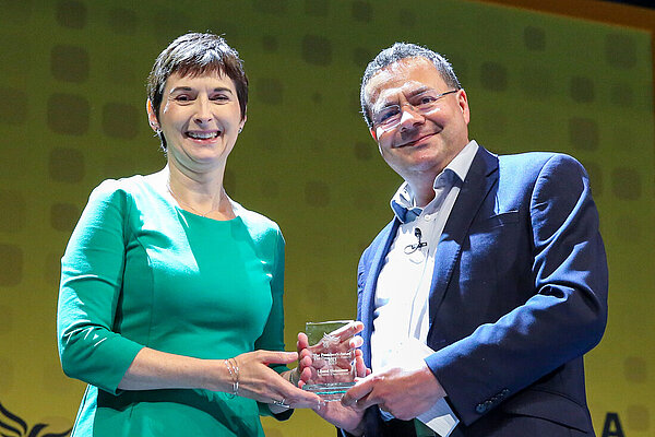 Caroline Pidgeon AM receives an award from Party President Mark Pack