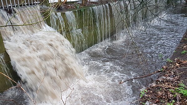 Sewage being discharged into a river.