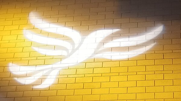 Lib Dem logo bird projected on blockwork