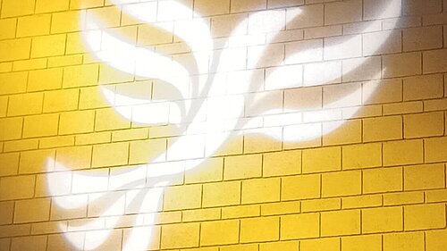 Lib Dem logo bird projected on blockwork