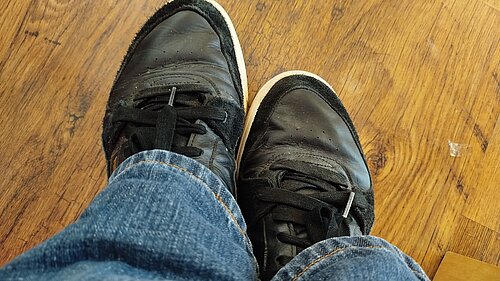 Feet wearing trainers / shoes