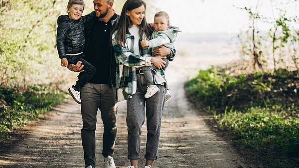 A family walks through a forest