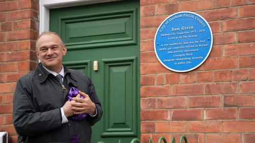Ed Davey next to a blue plaque for Sam Green