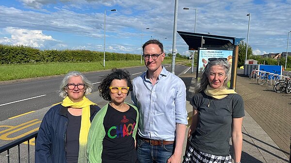 Edna Murphy, Firouz Thompson, Ian Sollom, Ros Hathorn in front of the bus stop