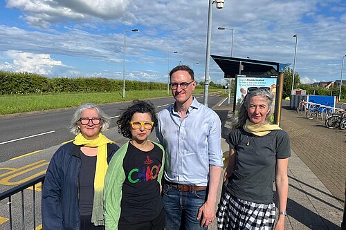 Edna Murphy, Firouz Thompson, Ian Sollom, Ros Hathorn in front of the bus stop