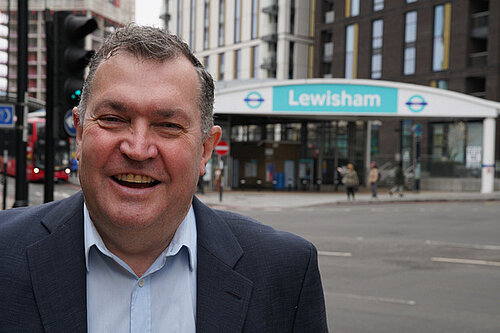 Chris Maines standing in front of Lewisham DLR station