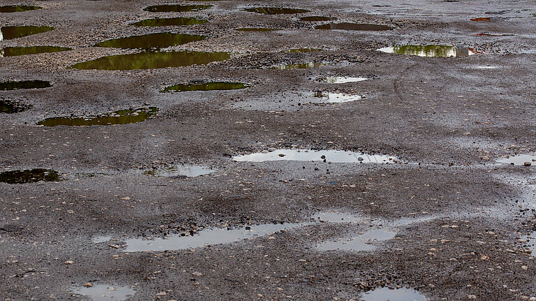 A road filled with potholes.