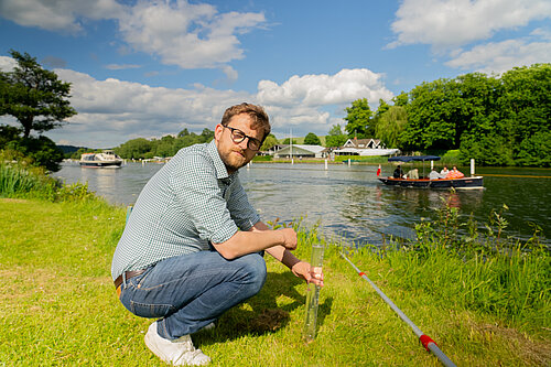 Freddie next to the river Thames testing water quality