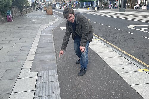 Jack Caldwell pointing at a bike lane