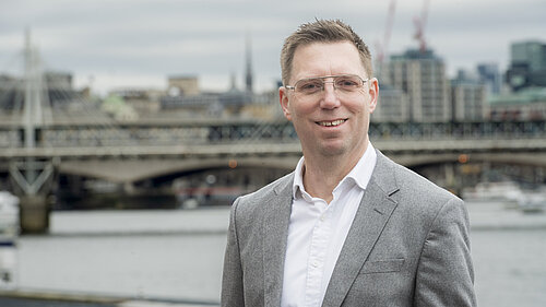 Rob Blackie pictured in a grey blazer with a white shirt