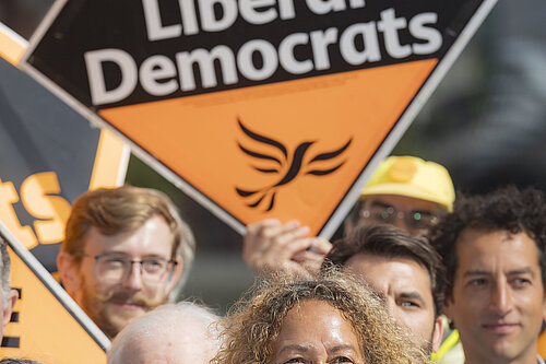 Liberal Democrat activists pictured with signs