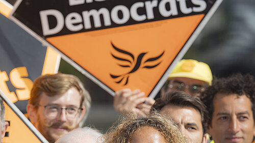 Liberal Democrat campaigners pictured with signs