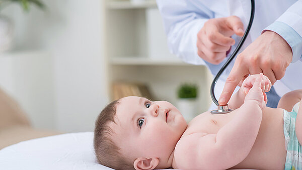 A baby being checked using a stethoscope.