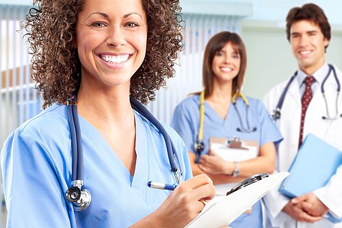 Three doctors smiling.