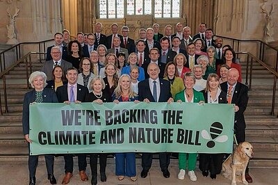 Lib Dem (and other) MPs in Parliament holding climate and nature bill banner