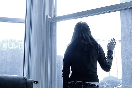 A woman looking out a window.