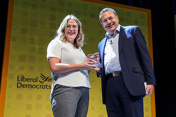 Millie Earl receives an award from Party President Mark Pack