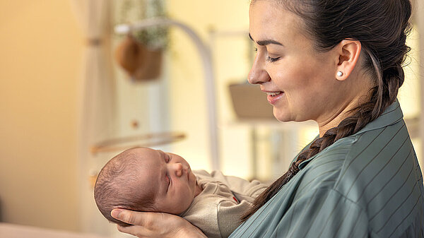 A mother holds their baby