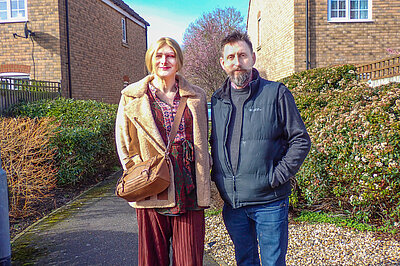 Full length image of Sarah Marsh and ALec Jones in an alleyway between houses in Sohma North