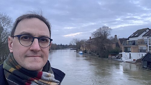 Ian Sollom standing in front of the river in St Neots