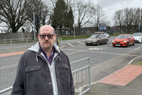 Iain with the development site in the background.