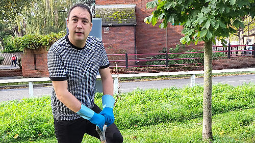 Cllr Gary Busuttil planting a tree.