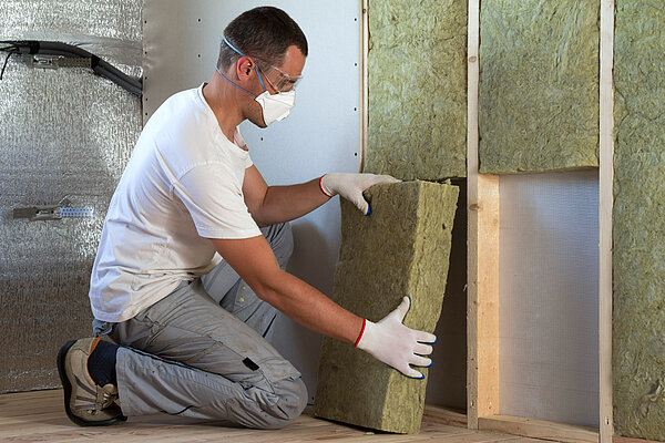 Home Insulation A man fitting home insulation