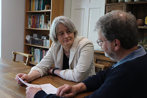 Claire Young speaking to a resident about their energy bill