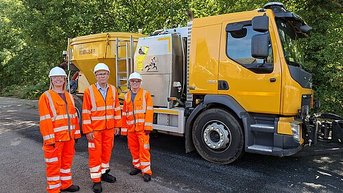 Councillors with repair machine 