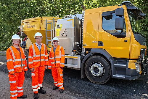 Councillors with repair machine 