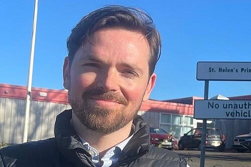 Adam Harley standing outside St Helen's primary school in Bishopbriggs