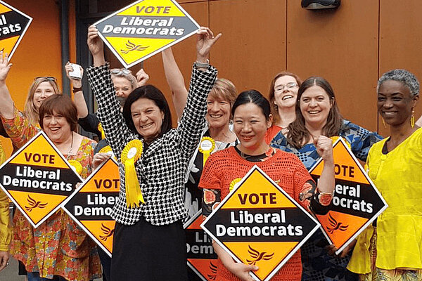 South Cambridgeshire A group of Liberal Democrats holding signs and celebrating winning